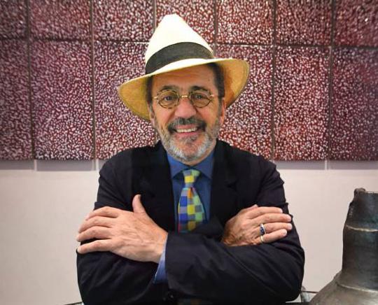 photo of smiling man with glasses and hat